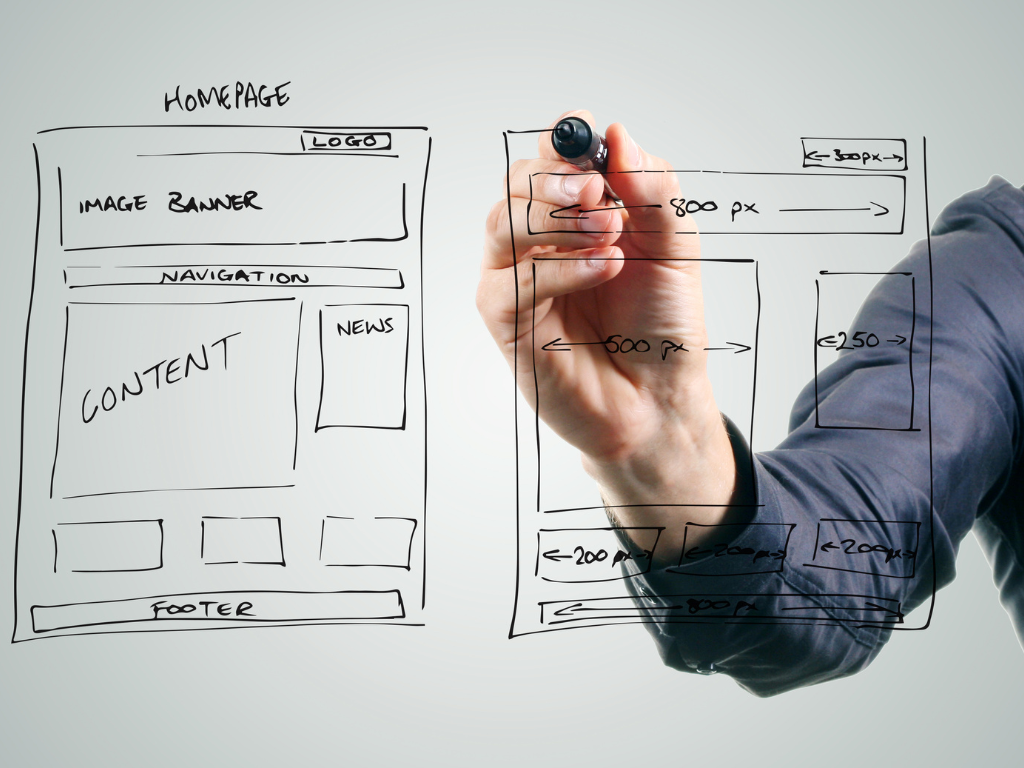 Designer sketching a website wireframe on glass, visualizing layout structure and elements for a CRO-driven redesign focused on user experience and conversion optimization.